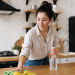 Žena čistí stôl v kuchyni pomocou trisódu.