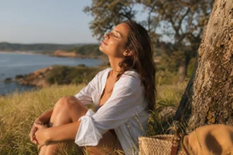 Žena relaxuje pri vode a vychutnáva slnečné svetlo